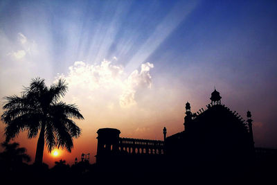 Low angle view of silhouette built structure against sky at sunset