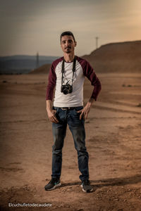 Portrait of young man standing on land