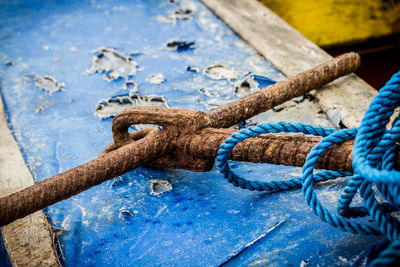 Close-up of rope tied to boat moored at harbor