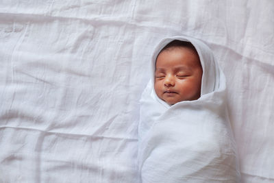 Cute boy sleeping on bed