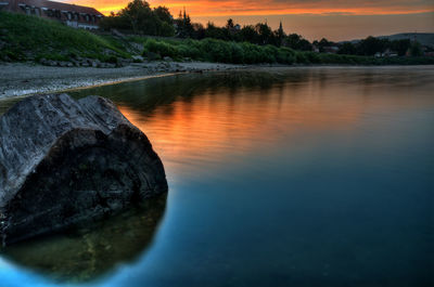 Scenic view of river at sunset