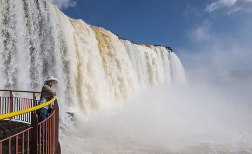 Woman in front of the iguacu waterfalls in brazil