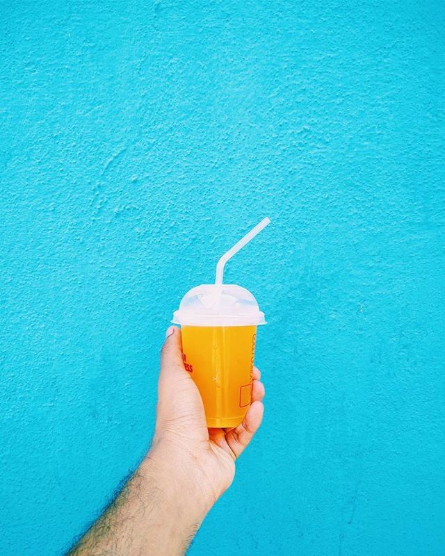 person, holding, food and drink, part of, cropped, personal perspective, freshness, human finger, food, blue, refreshment, unrecognizable person, drink, close-up, drinking straw, healthy eating, frozen food