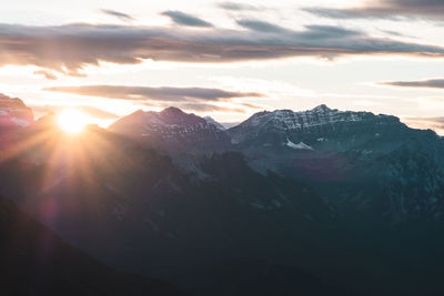 Scenic view of snowcapped mountains against sky during sunset