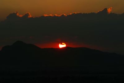 Scenic view of silhouette mountains against romantic sky at sunset