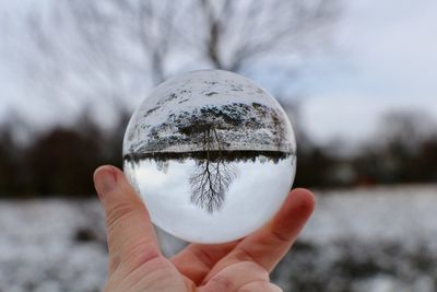 Close-up of human hand holding crystal ball