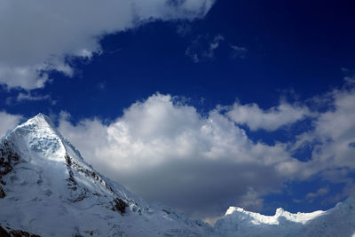 Scenic view of mountains against cloudy sky