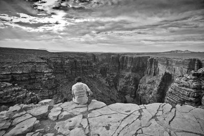 Rock formations on landscape against cloudy sky