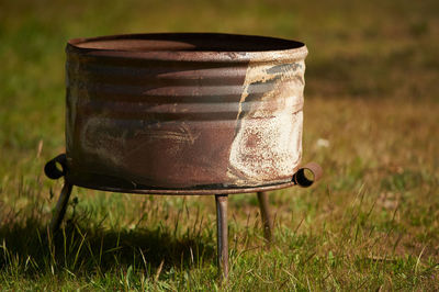 Close-up of old tea light on field