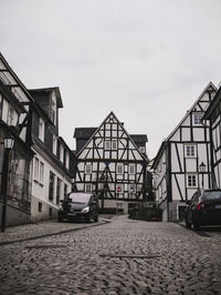 Street amidst buildings in city against sky