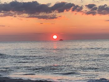 Scenic view of sea against romantic sky at sunset