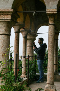 Rear view of young man standing in tunnel