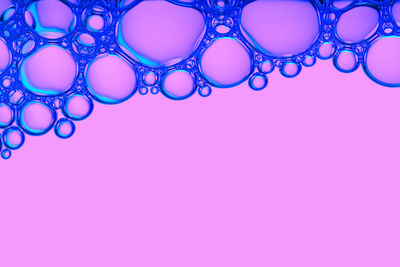 Close-up of bubbles against blue background