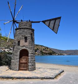 Traditional windmill against clear blue sky