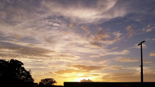 High section of silhouette trees against scenic sky