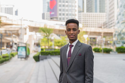 Portrait of businessman standing in city