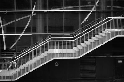 Full length side view of boy climbing on steps in city