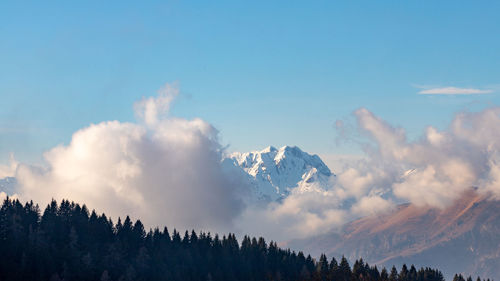 Low angle view of snowcapped mountains against sky