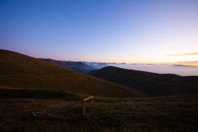 Scenic view of field against sky during sunset