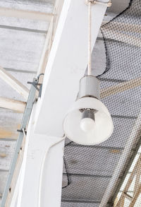 Low angle view of electric lamp hanging on ceiling