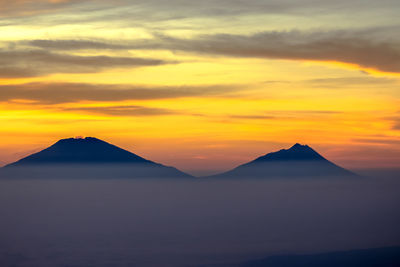 Scenic view of silhouette mountains against sky during sunset