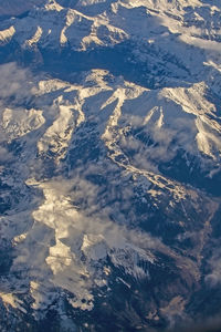 Aerial view of snowcapped mountains against sky