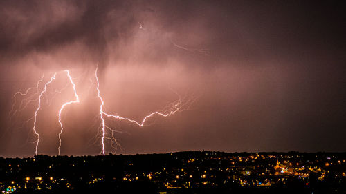 Lightning in sky over cityscape