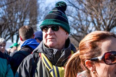 Portrait of man wearing sunglasses against sky during winter