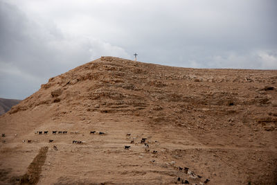 Low angle view of arid landscape against sky