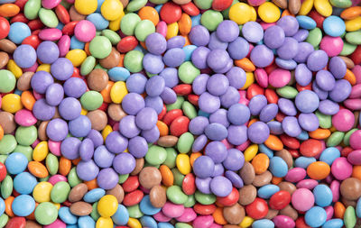 Texture of multi-colored candies, the letters of the color of the year very peri