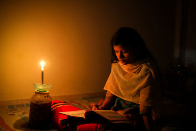 Girl sitting on table at home