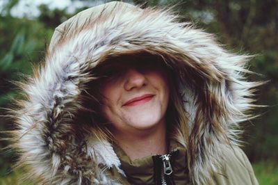 Portrait of smiling woman wearing fur coat