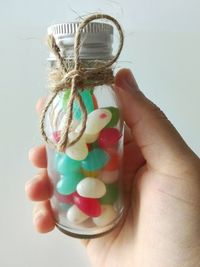 Close-up of hand holding multi colored candies