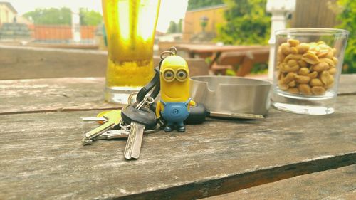 Close-up of keys with figurine on wooden table