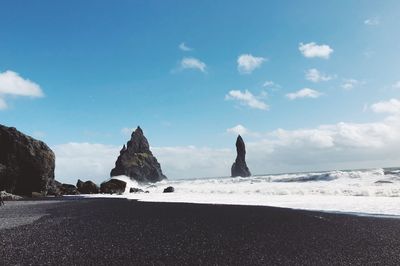 Scenic view of beach against blue sky