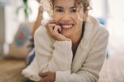 Portrait of young woman sitting at home