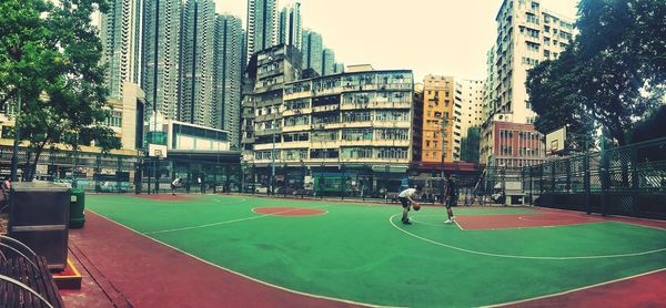 Man playing basketball in city