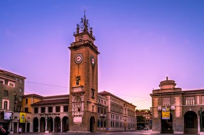 Clock tower in city against clear sky