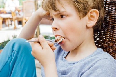 Cute boy having of ice cream in spoon