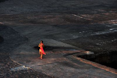 Women in red, lone on a pier