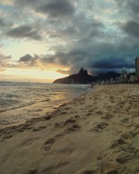 Scenic view of beach against sky during sunset