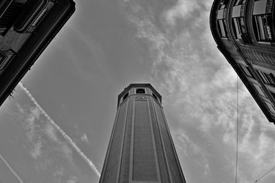 Low angle view of buildings against cloudy sky