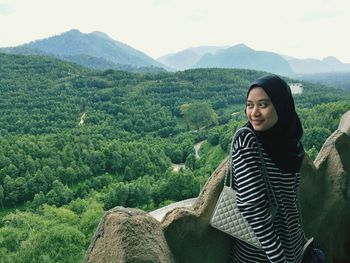 Portrait of young woman in mountains