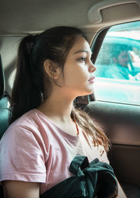 Young woman sitting in car