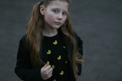 Portrait of cute girl standing outdoors