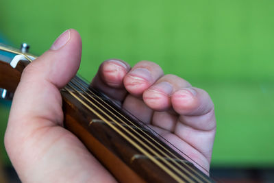 Hand holding guitar