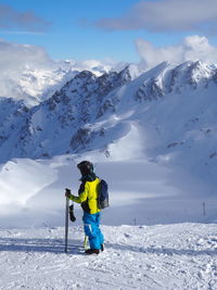 High angle view of skier standing on snow covered field