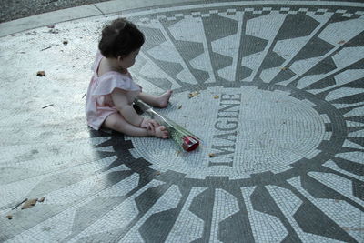 High angle view of girl playing on floor