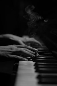 Close-up of person hands playing piano