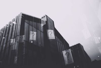 Low angle view of road sign against clear sky